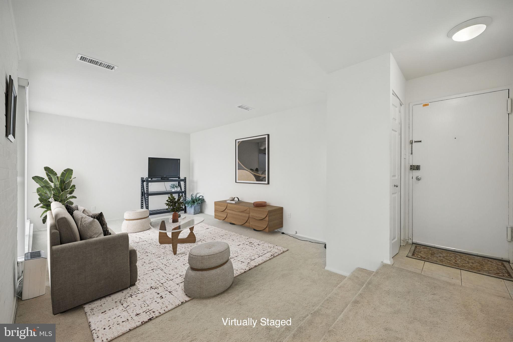 2107 Walsh View Terrace, Unit 14301 & 304 Silver Spring, MD 20902 - Photo 3 of 54 a living room with furniture and a flat screen tv