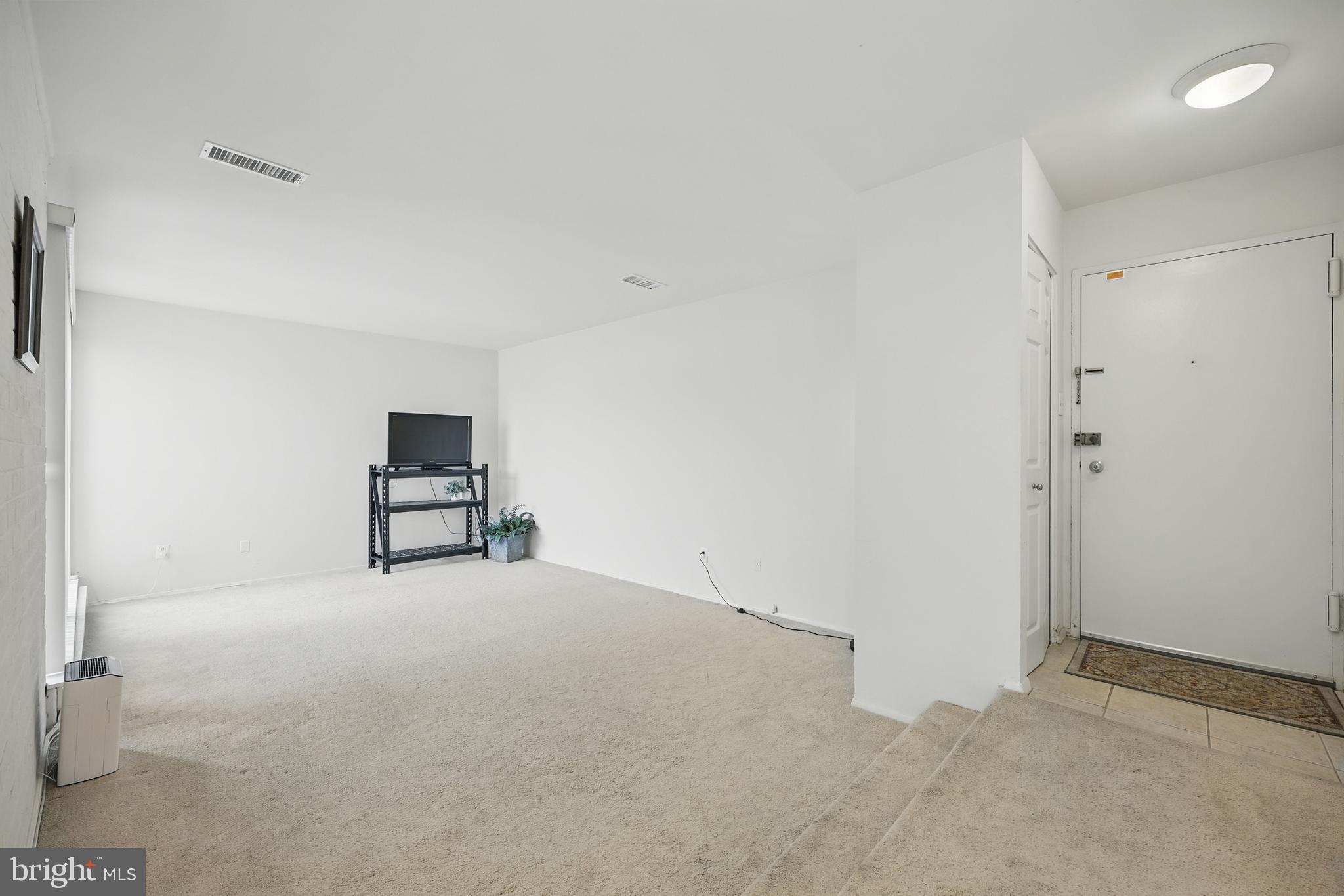 2107 Walsh View Terrace, Unit 14301 & 304 Silver Spring, MD 20902 - Photo 4 of 54 a view of empty room with racks on the wall
