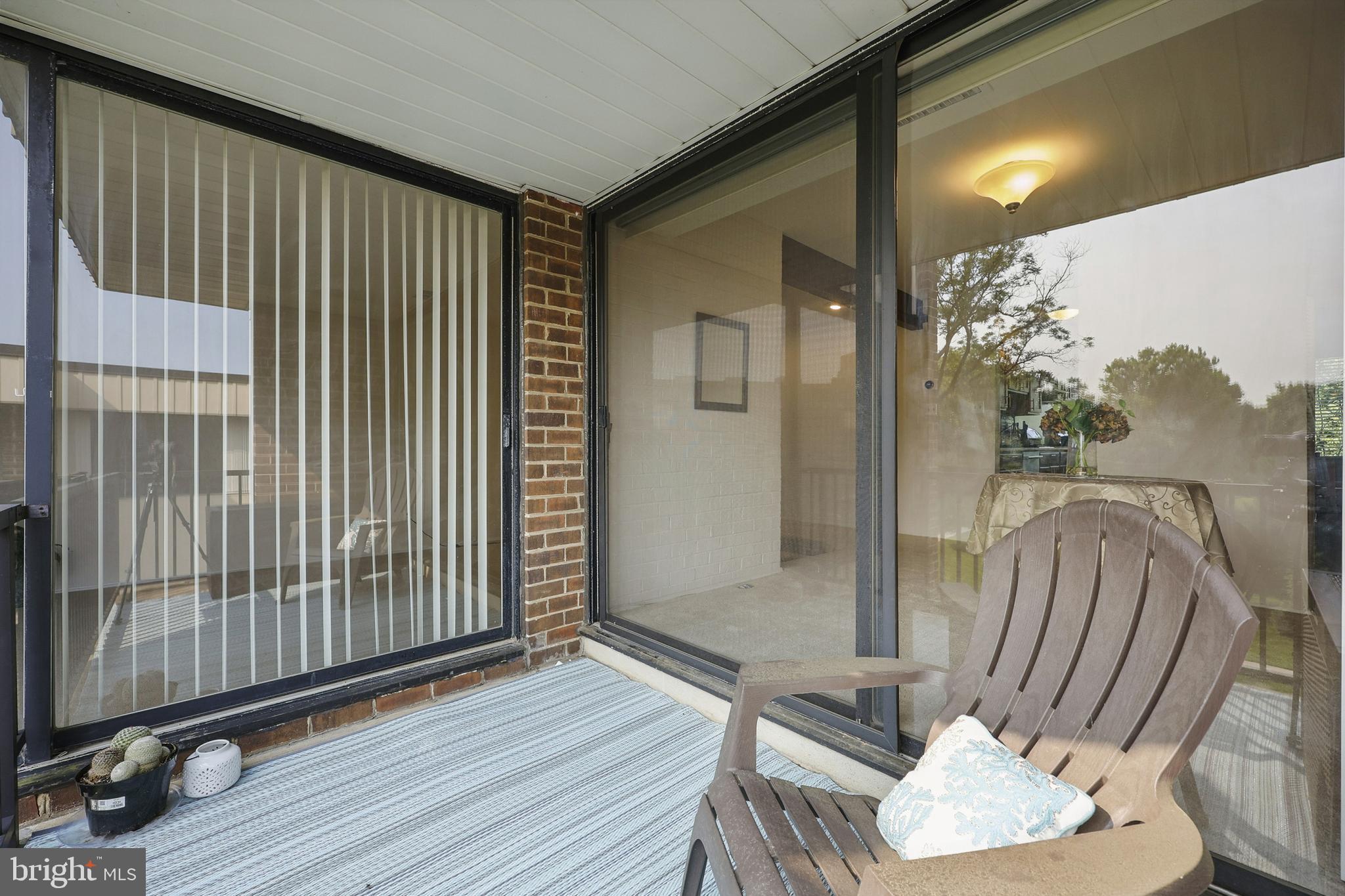 2107 Walsh View Terrace, Unit 14301 & 304 Silver Spring, MD 20902 - Photo 10 of 54 a view of a balcony with chair and wooden floor
