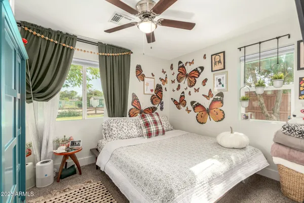 a bedroom with a large bed and a window