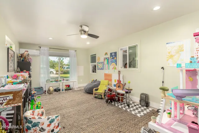 a living room with furniture a window and gym equipment