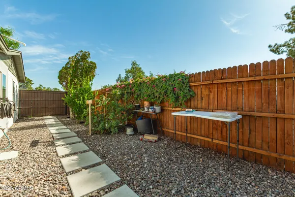 a view of a backyard with wooden fence