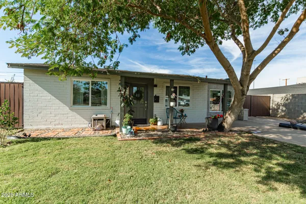 a view of a house with backyard porch and sitting area