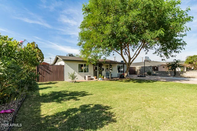 a view of a house with swimming pool and sitting area
