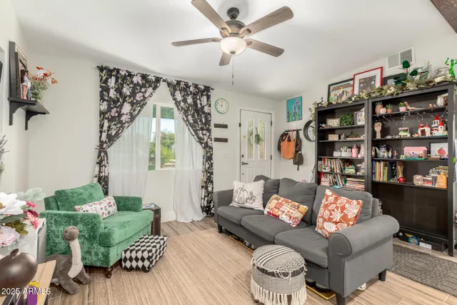 a living room with furniture and a book shelf