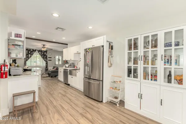 a kitchen with stainless steel appliances a refrigerator and a stove top oven