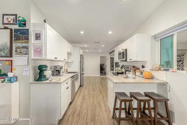 a kitchen with stainless steel appliances kitchen island granite countertop a sink and cabinets