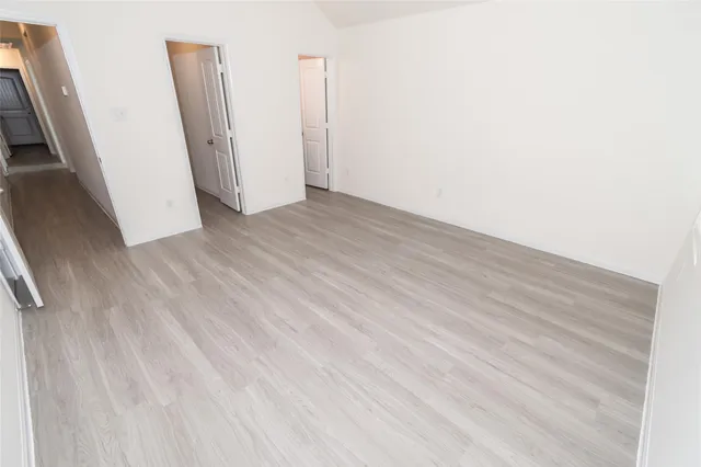 an empty room with wooden floor