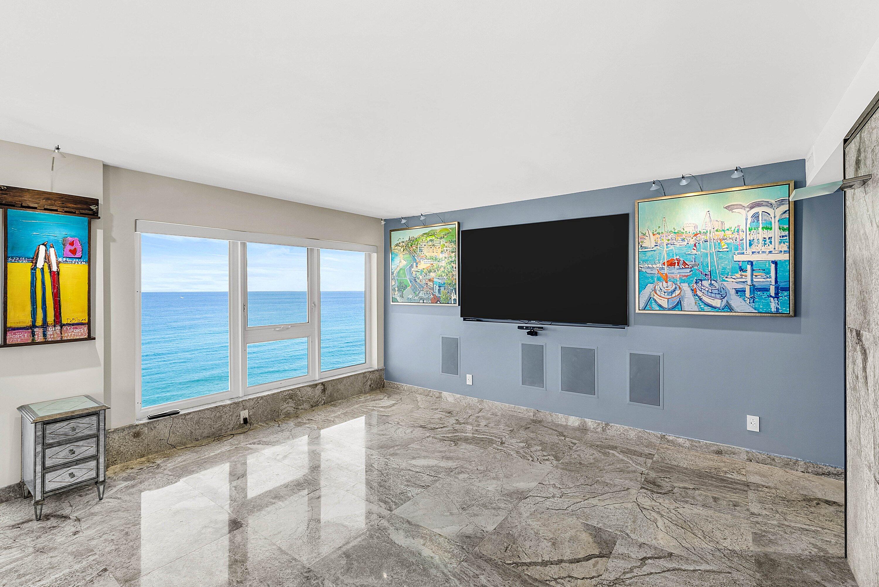 2066 North Ocean Boulevard, Unit 9NE Boca Raton, FL 33431 - Photo 12 of 45 a living room with flat screen tv and floor to ceiling window