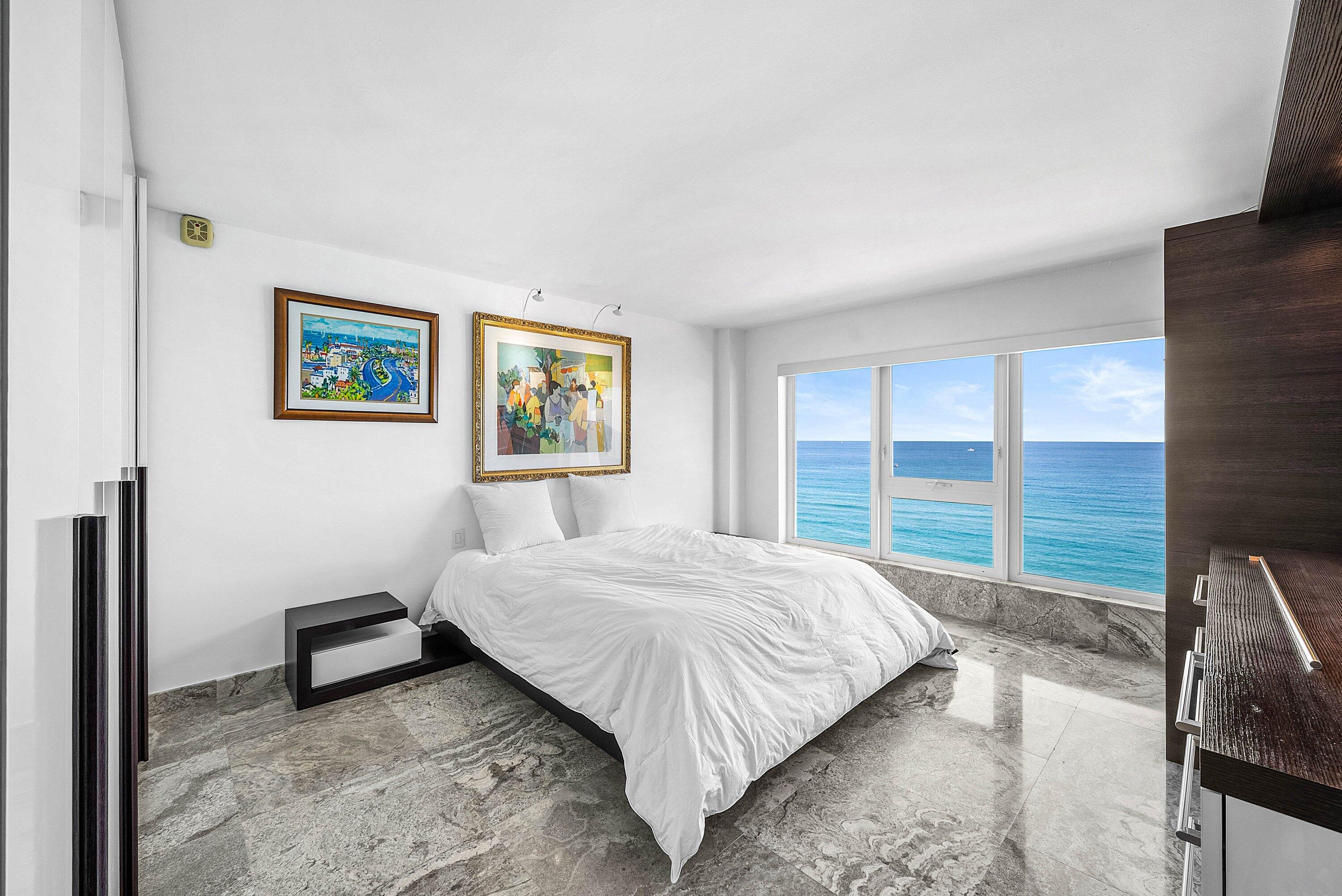 2066 North Ocean Boulevard, Unit 9NE Boca Raton, FL 33431 - Photo 24 of 45 a bedroom with a bed and a large window