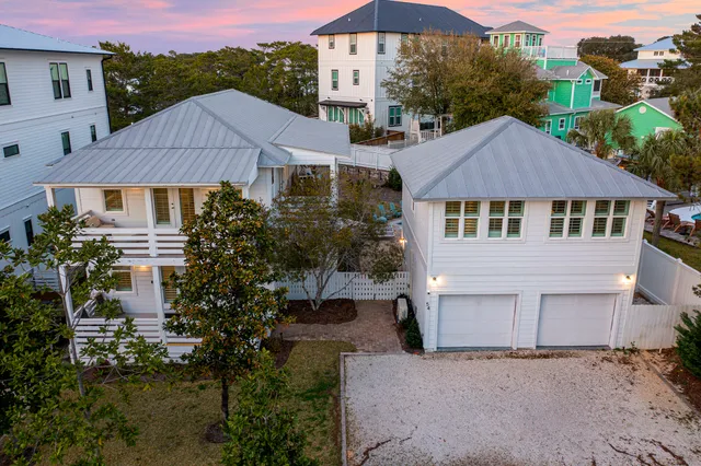 an aerial view of a house with yard and mountain view in back