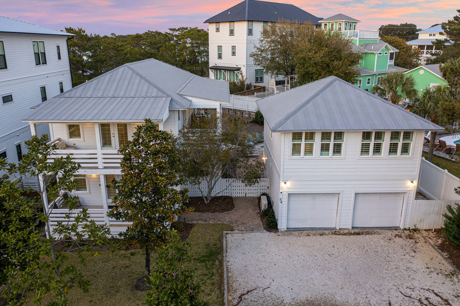 an aerial view of a house with yard and mountain view in back