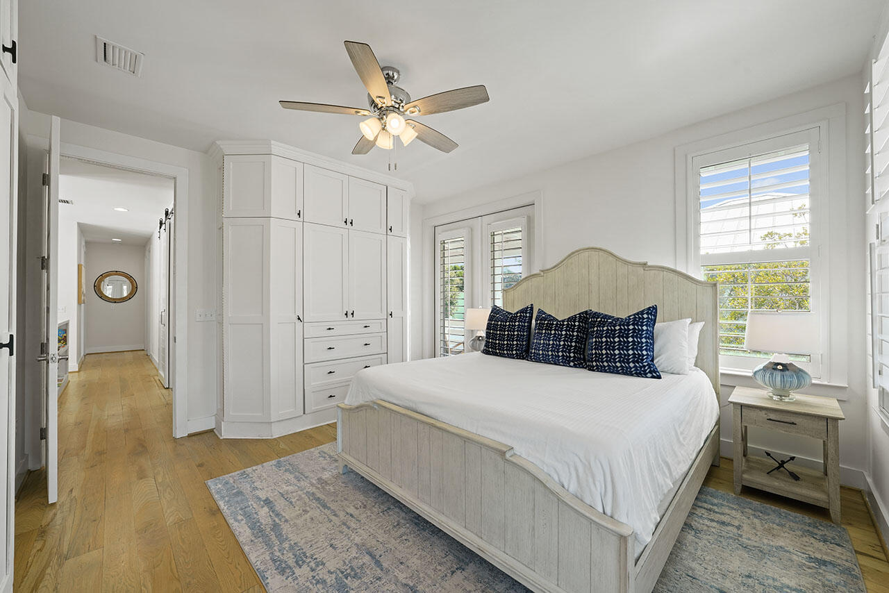 54 Dune Drive Santa Rosa Beach, FL 32459 - Photo 12 of 42 a spacious bedroom with a bed and a chandelier