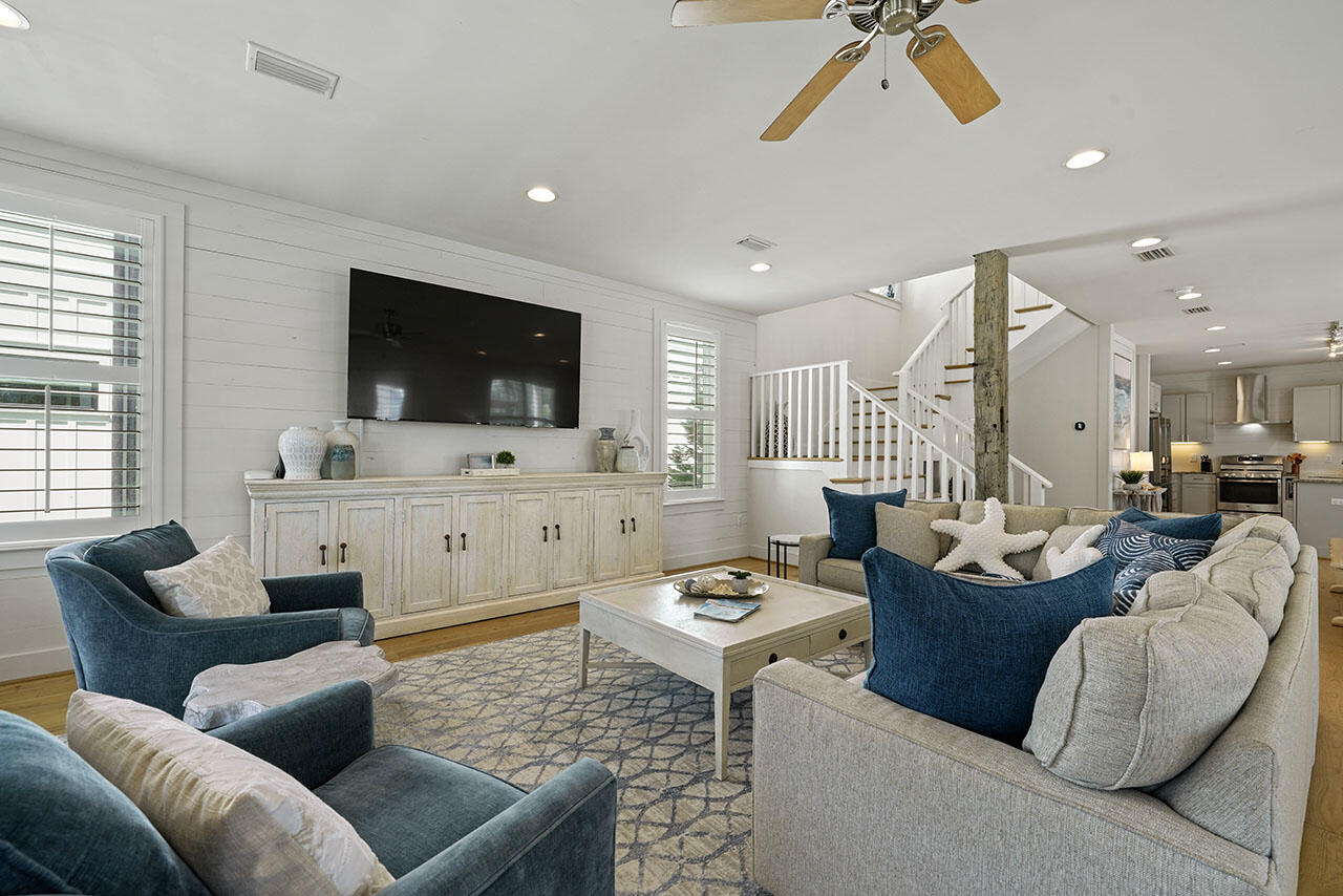 54 Dune Drive Santa Rosa Beach, FL 32459 - Photo 27 of 42 a living room with furniture kitchen view and a flat screen tv