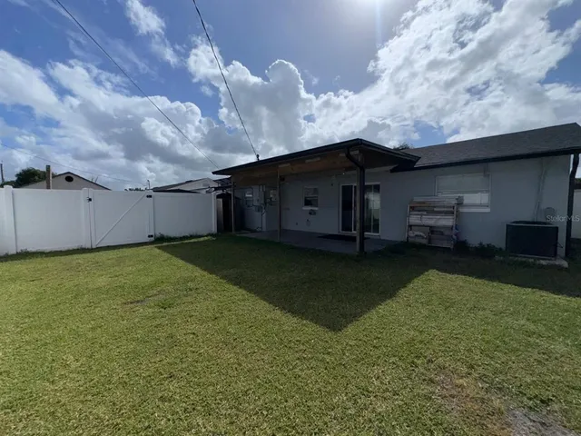 a view of a house with a backyard