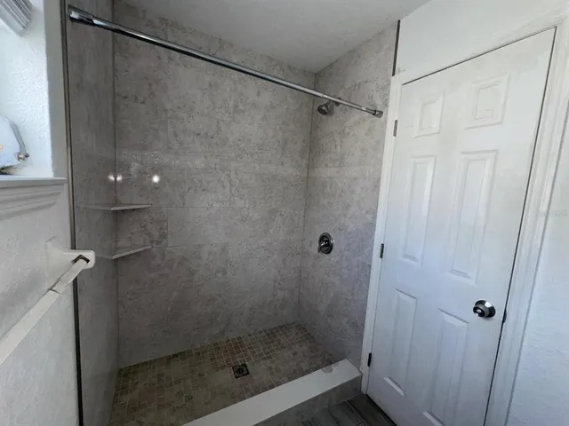 a bathroom with a glass shower door