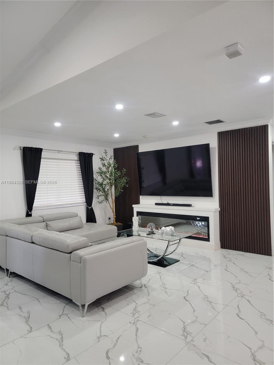 25209 Southwest 134th Avenue Homestead, FL 33032 - Photo 12 of 33 a living room with furniture and a flat screen tv