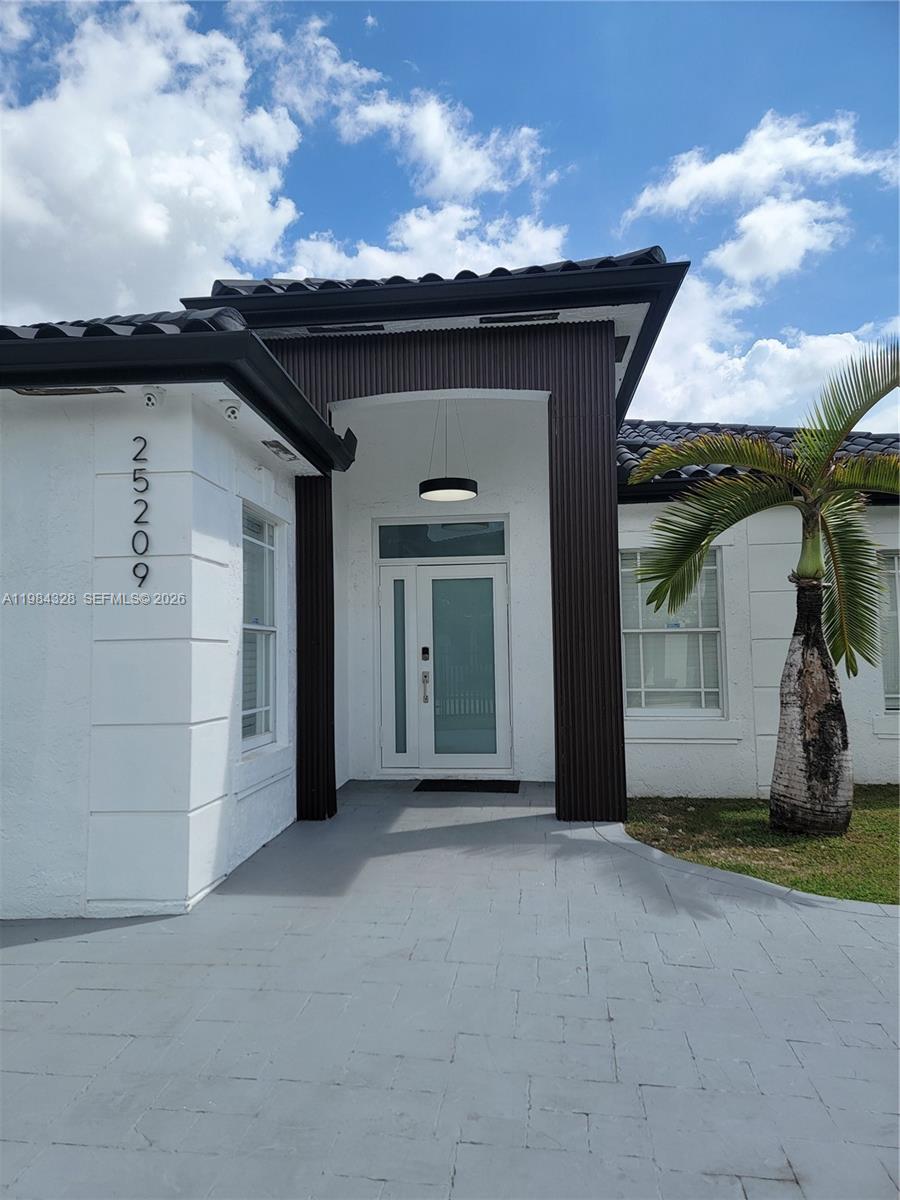 25209 Southwest 134th Avenue Homestead, FL 33032 - Photo 2 of 33 a view of a house with a porch