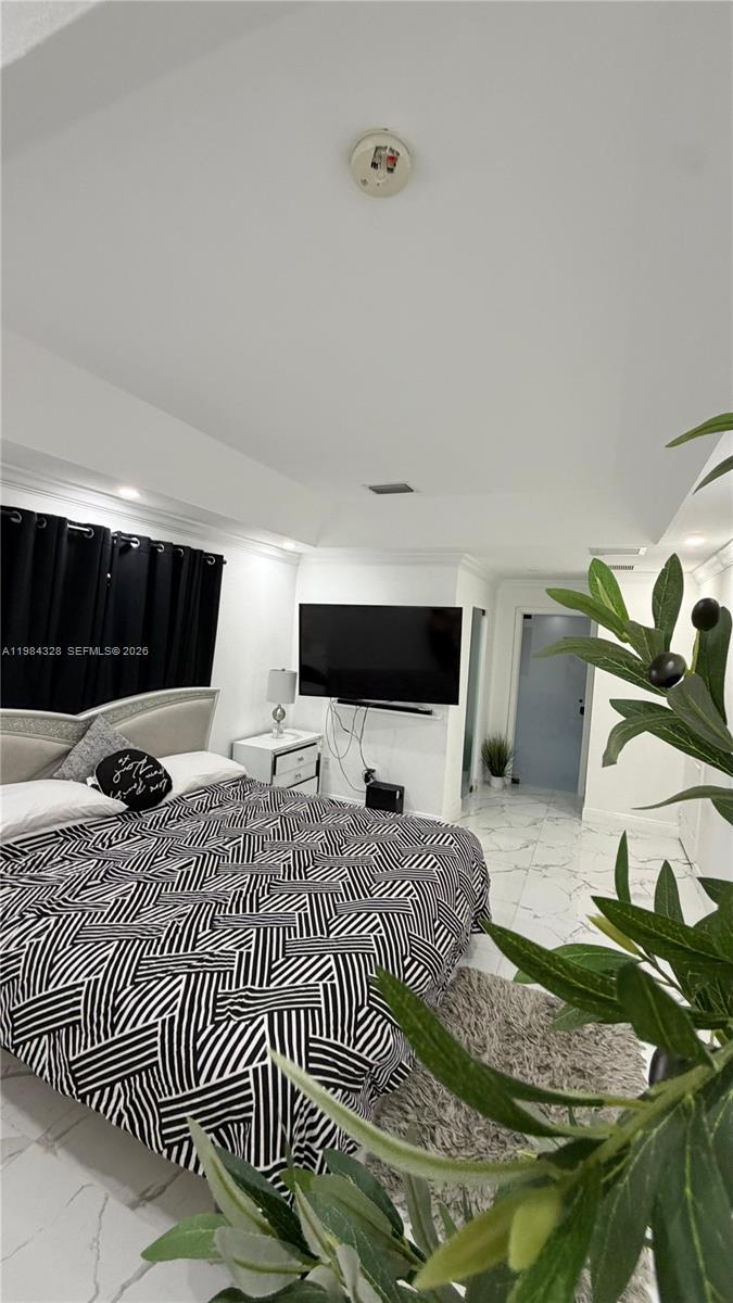 25209 Southwest 134th Avenue Homestead, FL 33032 - Photo 21 of 33 a bedroom with a bed and wooden floor
