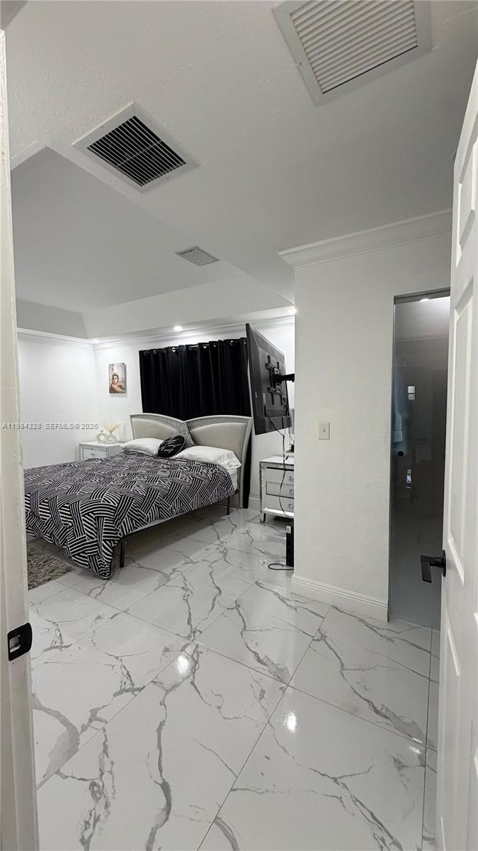 25209 Southwest 134th Avenue Homestead, FL 33032 - Photo 22 of 33 a bedroom with a bed and cabinets