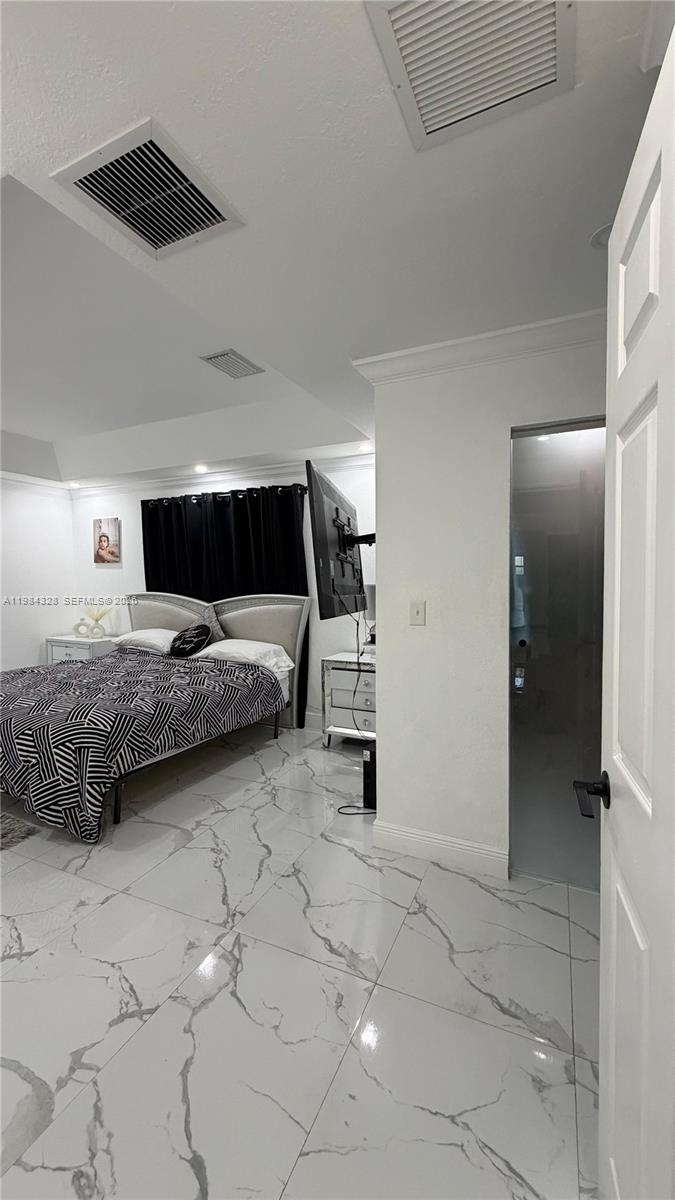 25209 Southwest 134th Avenue Homestead, FL 33032 - Photo 23 of 33 a bedroom with a bed and a walk in closet