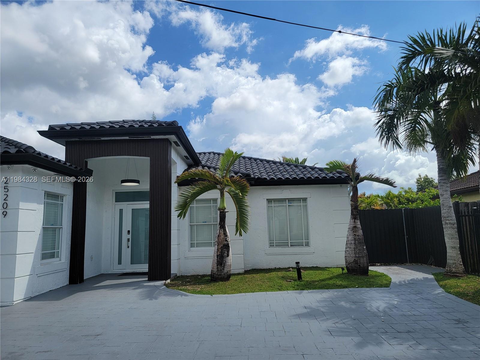 25209 Southwest 134th Avenue Homestead, FL 33032 - Photo 4 of 33 a house with trees in the background
