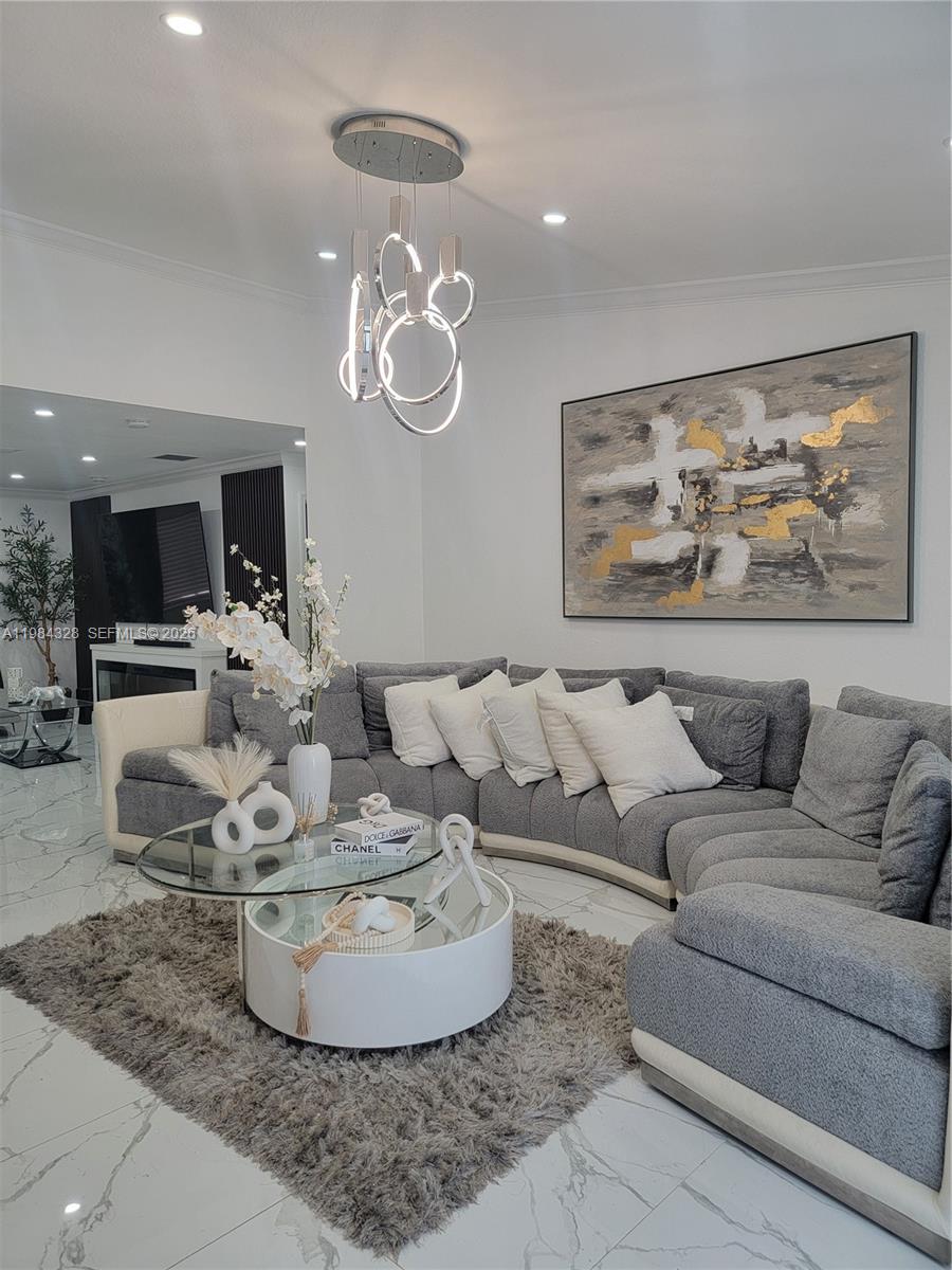 25209 Southwest 134th Avenue Homestead, FL 33032 - Photo 6 of 33 a living room with furniture chandelier and kitchen view