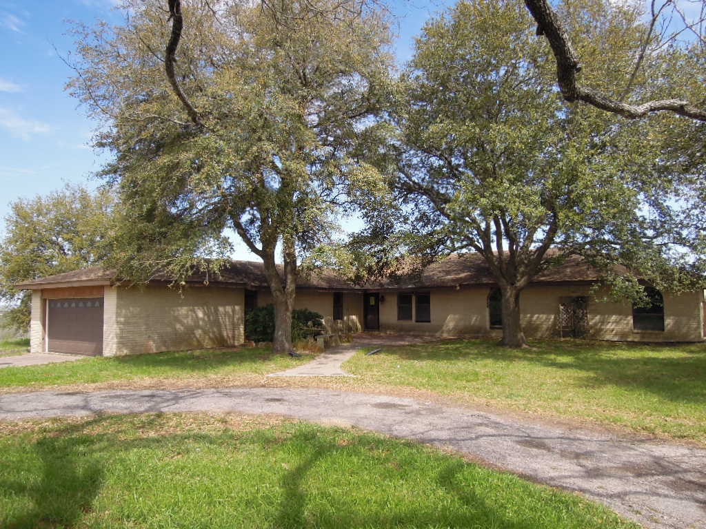19218 Lockwood Road Manor, TX 78653 - Photo 1 of 1 a front view of a house with a yard garage and outdoor seating