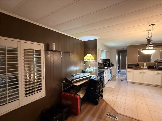 a kitchen with kitchen island white cabinets and stainless steel appliances