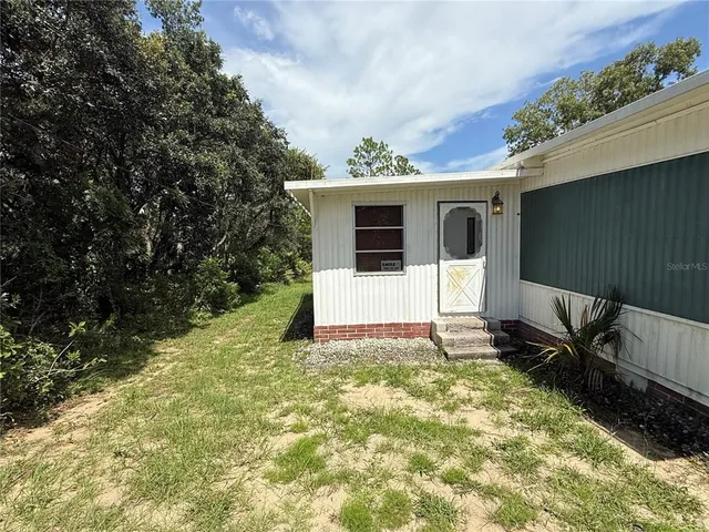 a view of a house with a yard and garage