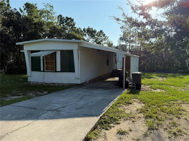 a view of a backyard with a large tree