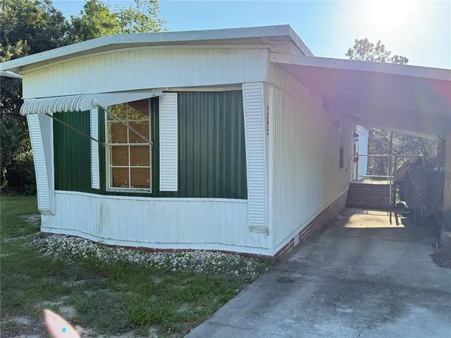 a view of front door and small yard