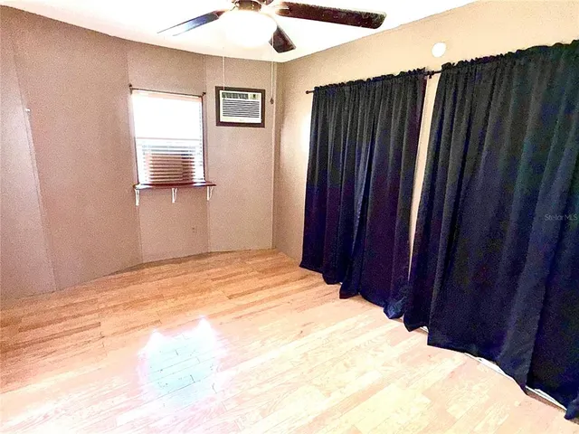 a bedroom with a bed and a mirror