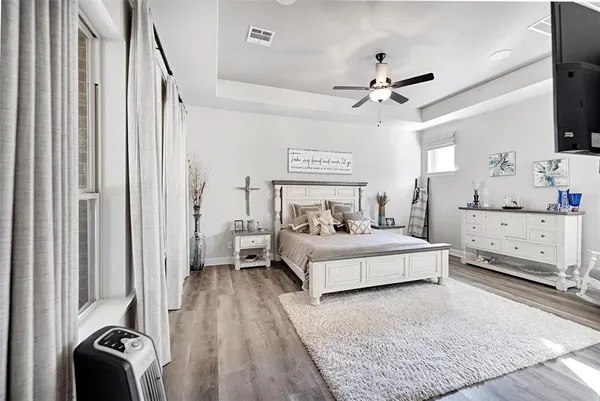 a view of bedroom with a bed and wooden floor