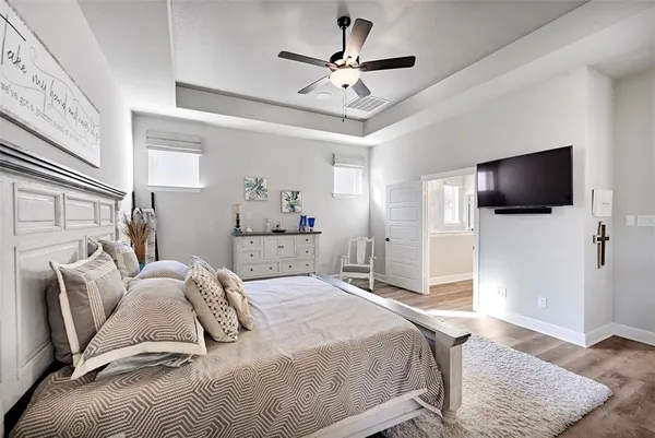a bedroom with a white bed and white walls