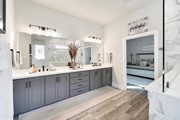 a large bathroom with a double vanity sink mirror and shower