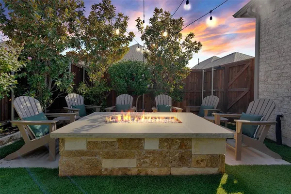 a view of a patio with table and chairs and potted plants