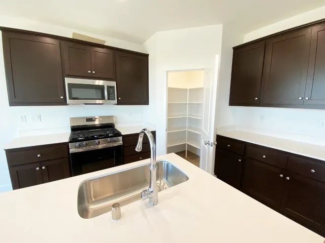 a kitchen with a sink and a stove top oven