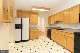 2022 Lakebreeze Way Reston, VA 20191 - Photo 14 of 25 a kitchen with granite countertop a refrigerator a sink and white cabinets