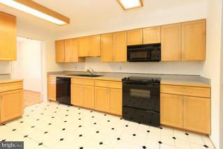 2022 Lakebreeze Way Reston, VA 20191 - Photo 15 of 25 a kitchen with a sink a stove and cabinets