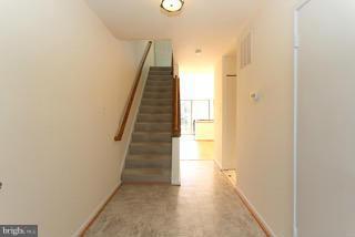 2022 Lakebreeze Way Reston, VA 20191 - Photo 18 of 25 a view of a hallway with wooden floor and staircase