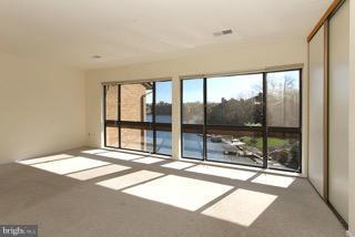 2022 Lakebreeze Way Reston, VA 20191 - Photo 19 of 25 a bedroom with a large window and a balcony