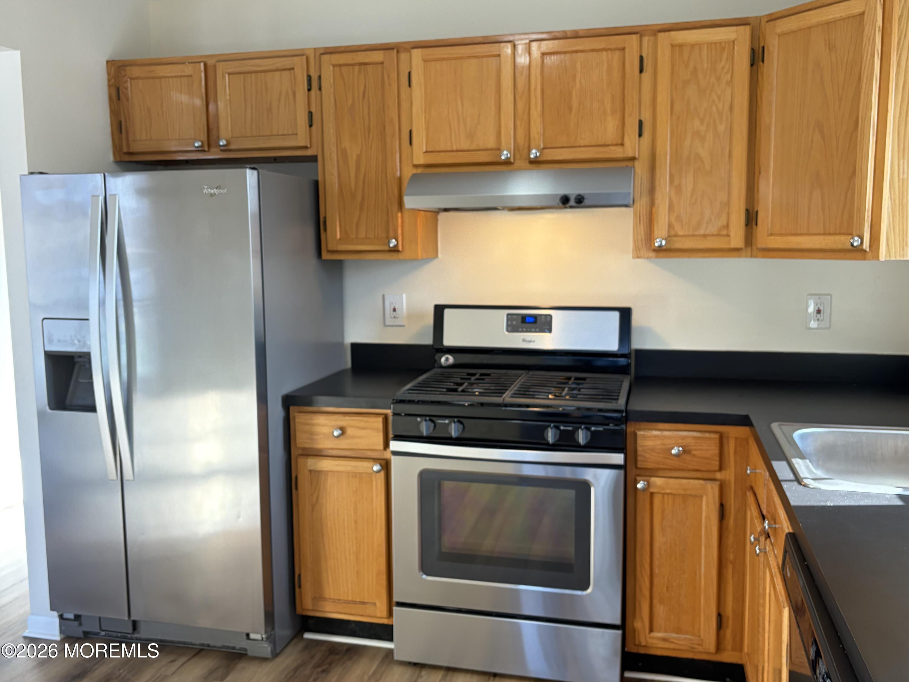231 Atlantic Street, Unit 33 Keyport, NJ 07735 - Photo 3 of 12 a kitchen with stainless steel appliances granite countertop a stove a refrigerator and a microwave
