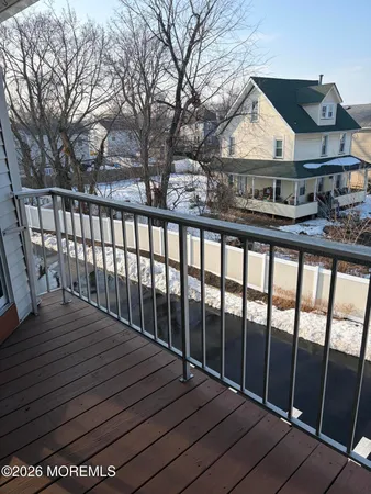 a view of a balcony with wooden floor