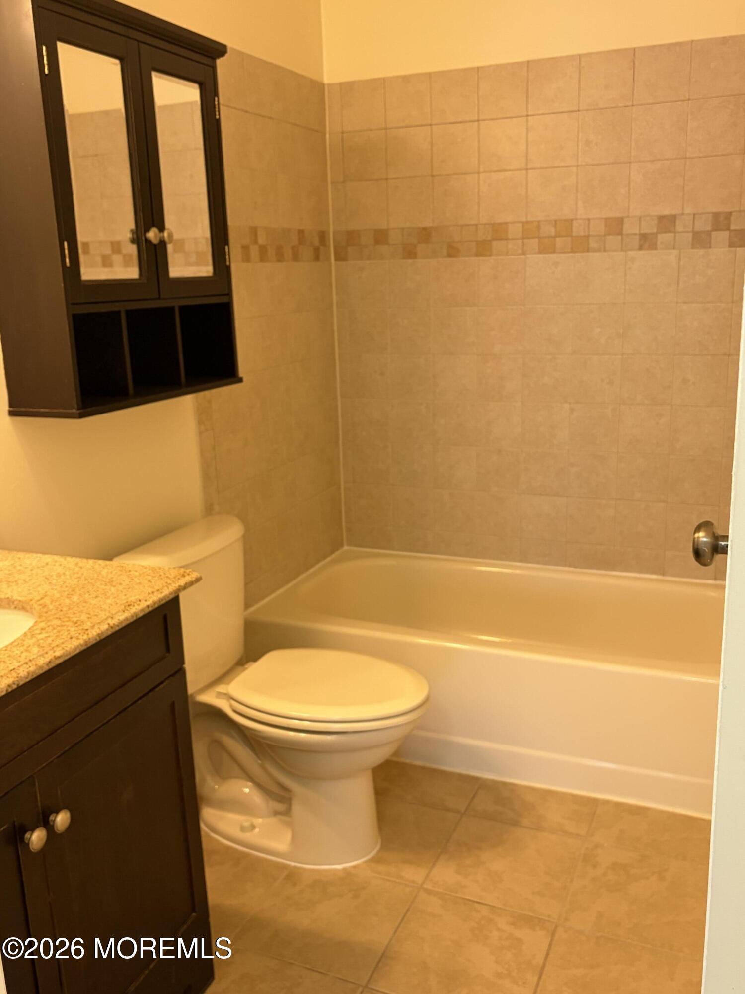 231 Atlantic Street, Unit 33 Keyport, NJ 07735 - Photo 9 of 12 a bathroom with a toilet and a shower