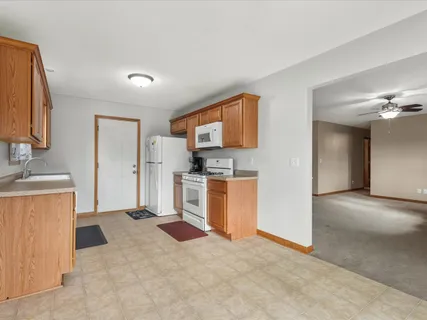 a view of a kitchen with a sink cabinet and a refrigerator