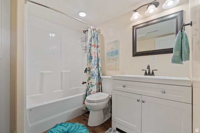 75 North 100th Street West Fillmore, UT 84631 - Photo 32 of 62 Bathroom with vanity, shower / bath combination with curtain, and dark wood finished floors