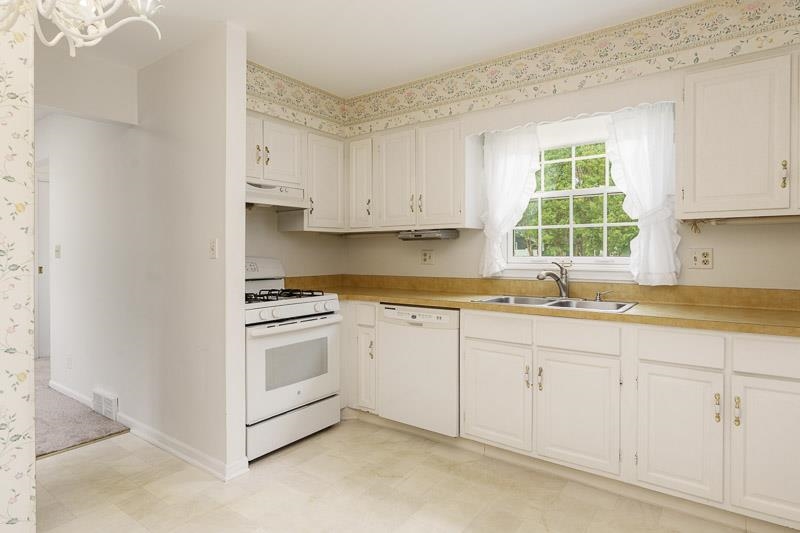 5792 Haddon Place Rockford, IL 61114 - Photo 12 of 47 a kitchen with granite countertop white cabinets and a sink