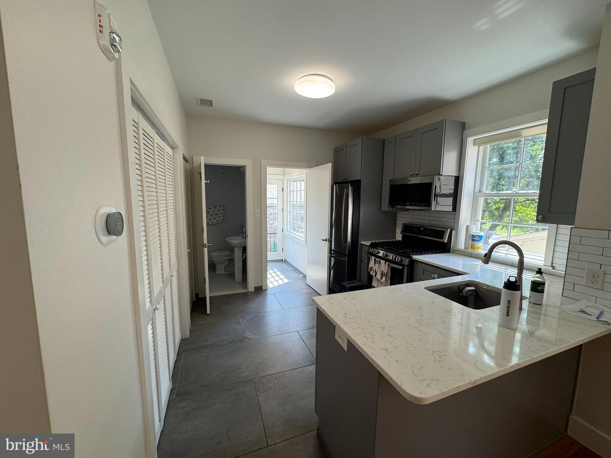 205 Witherspoon Street, Unit 2 Princeton, NJ 08542 - Photo 3 of 12 a kitchen with kitchen island a sink appliances and a counter top space