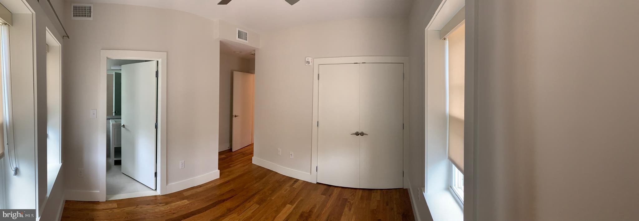 205 Witherspoon Street, Unit 2 Princeton, NJ 08542 - Photo 10 of 12 a view of a hallway with wooden floor and staircase